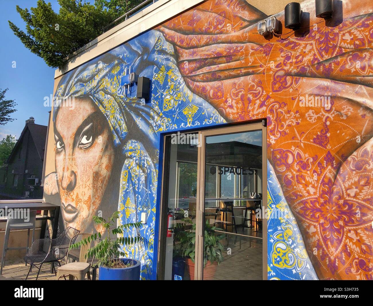 An colourful mural on an outdoor patio in Yorkville, a Toronto downtown neighbourhood. - Smartphone Captured Stock Image
