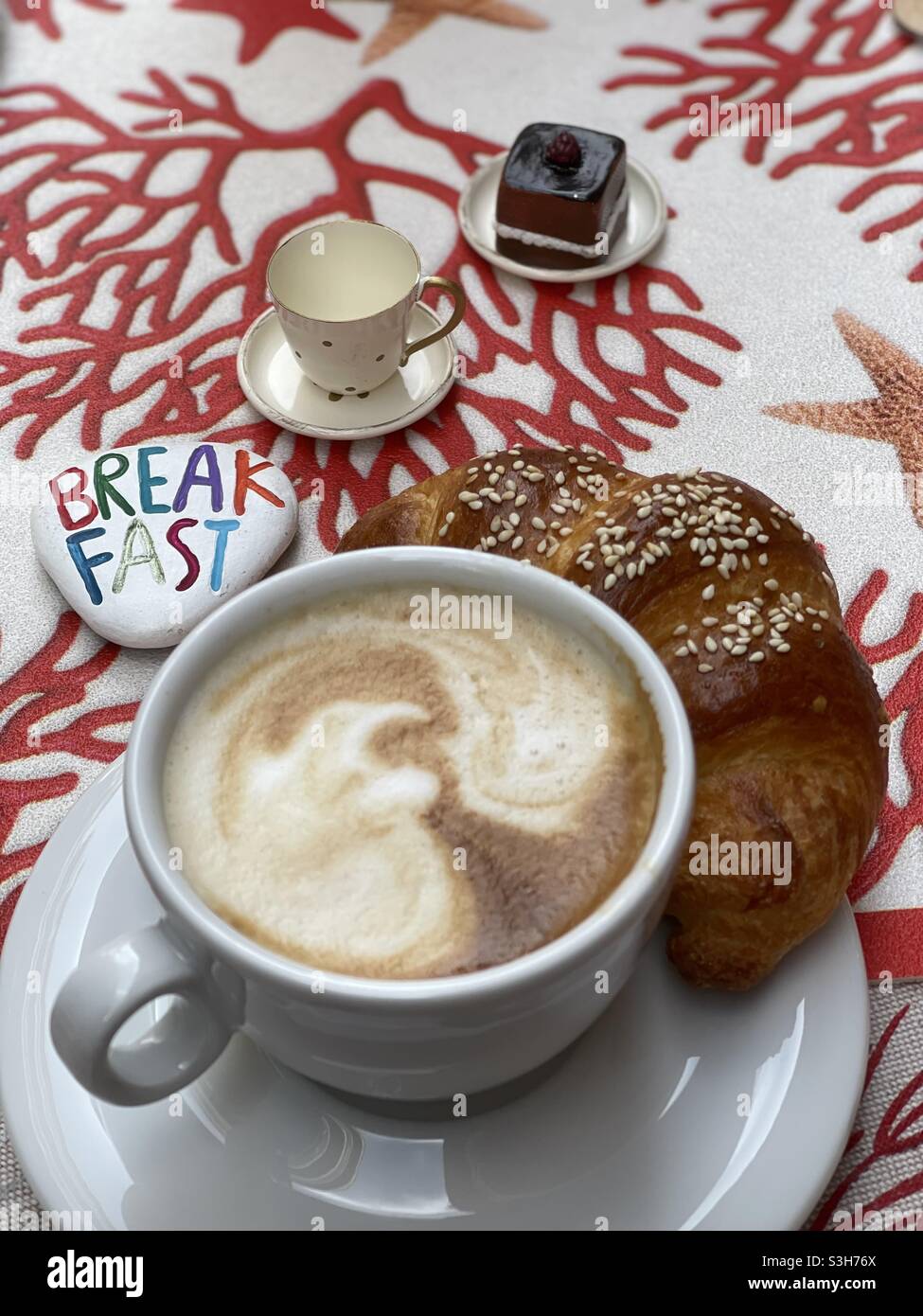 Kind breakfast at the bar with cappuccino, croissant and collection breakfast miniatures Stock Photo
