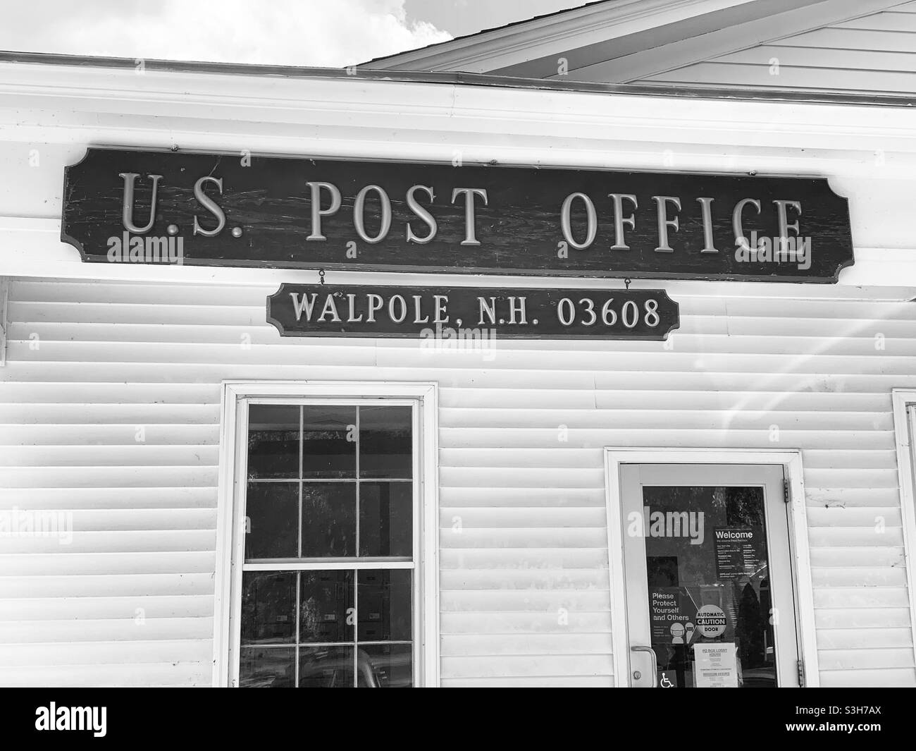 June, 2021, black and white image of the sign on the U.S. Post Office in Walpole, Cheshire County, New Hampshire, United States, North America - Smartphone Captured Stock Image