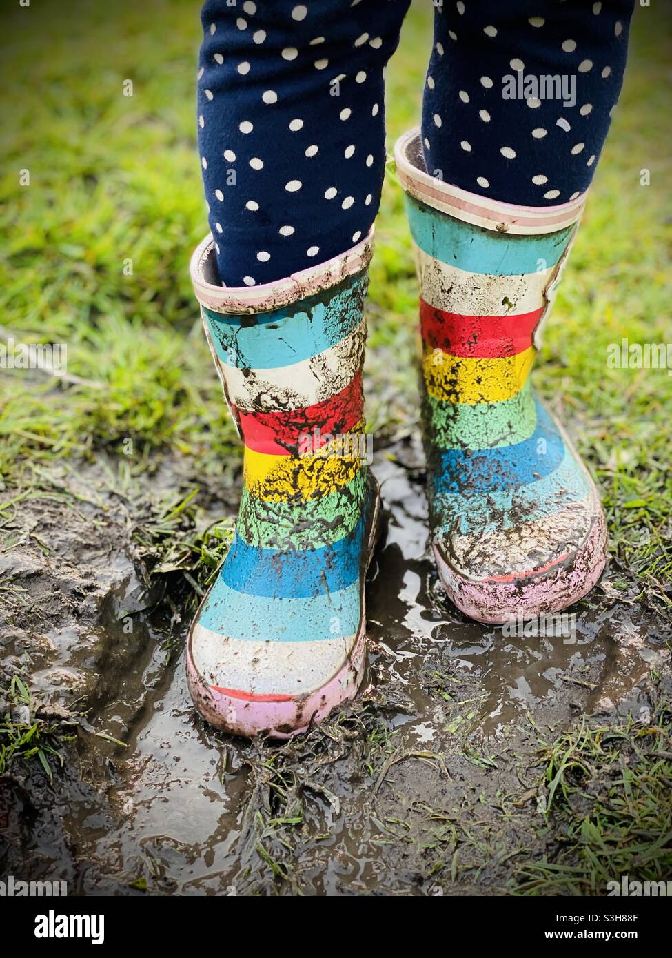 Walking in wellies in mud Stock Photo