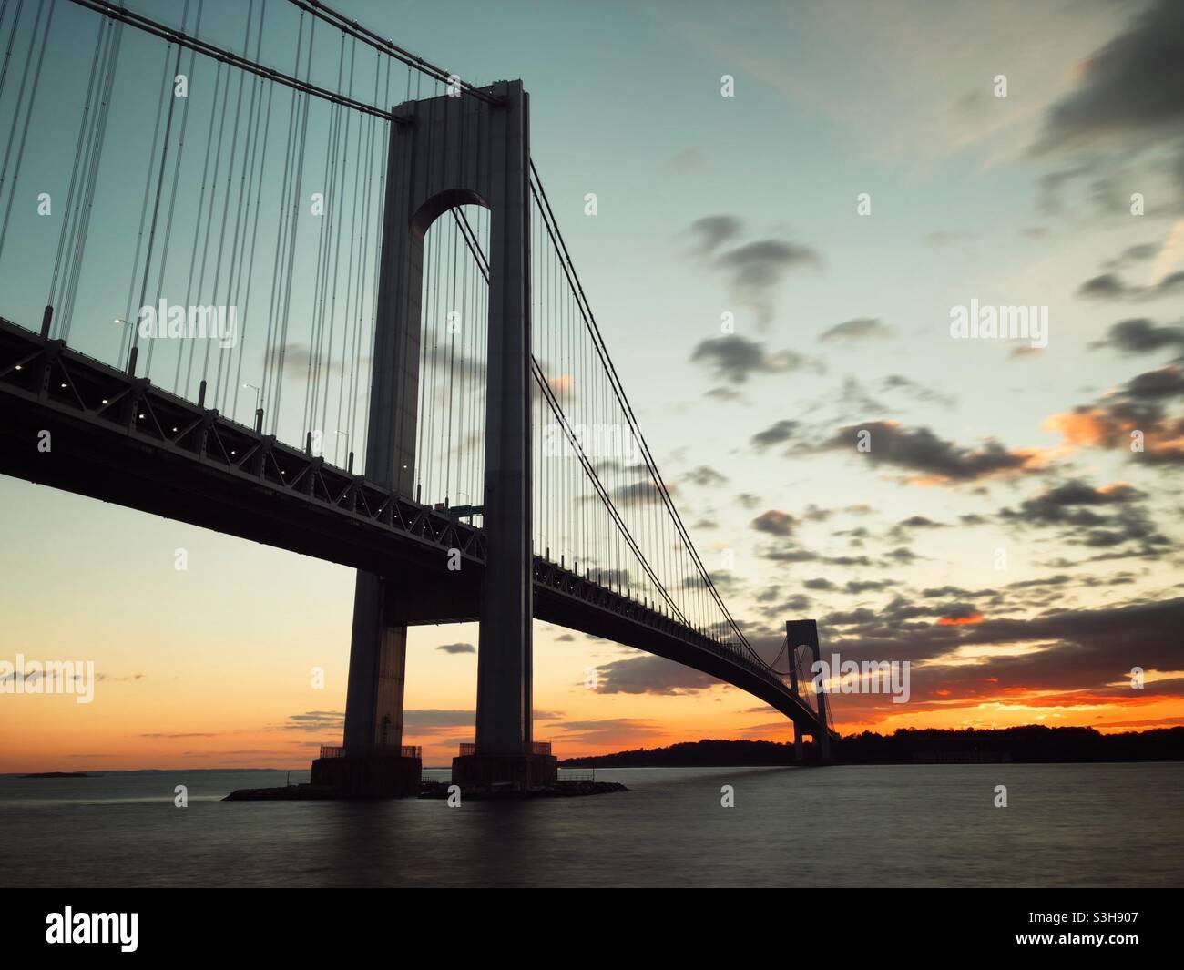 Verrazzano-Narrows Bridge as seen from Brooklyn,  New York at dusk. Staten Island can be seen in the distance. Stock Photo