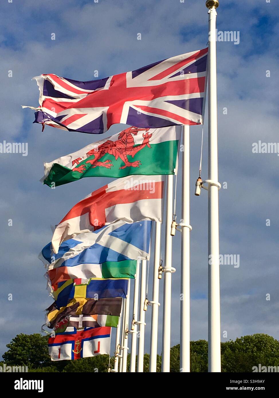 Flag poles with the flags of the countries of the British isles. Great Britain. Union Jack, St. George’s, welsh dragon, Scotland, Ireland, wales, England, RNLI Stock Photo