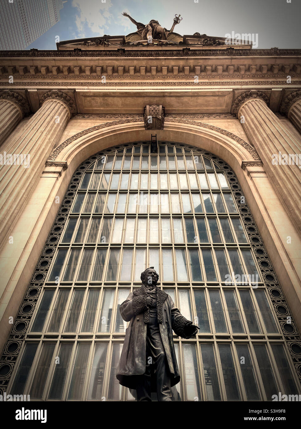 The statue of Cornelius Vanderbilt stands in front of Grand Central Station on the Park Avenue viaduct, NYC, USA - Smartphone Captured Stock Image