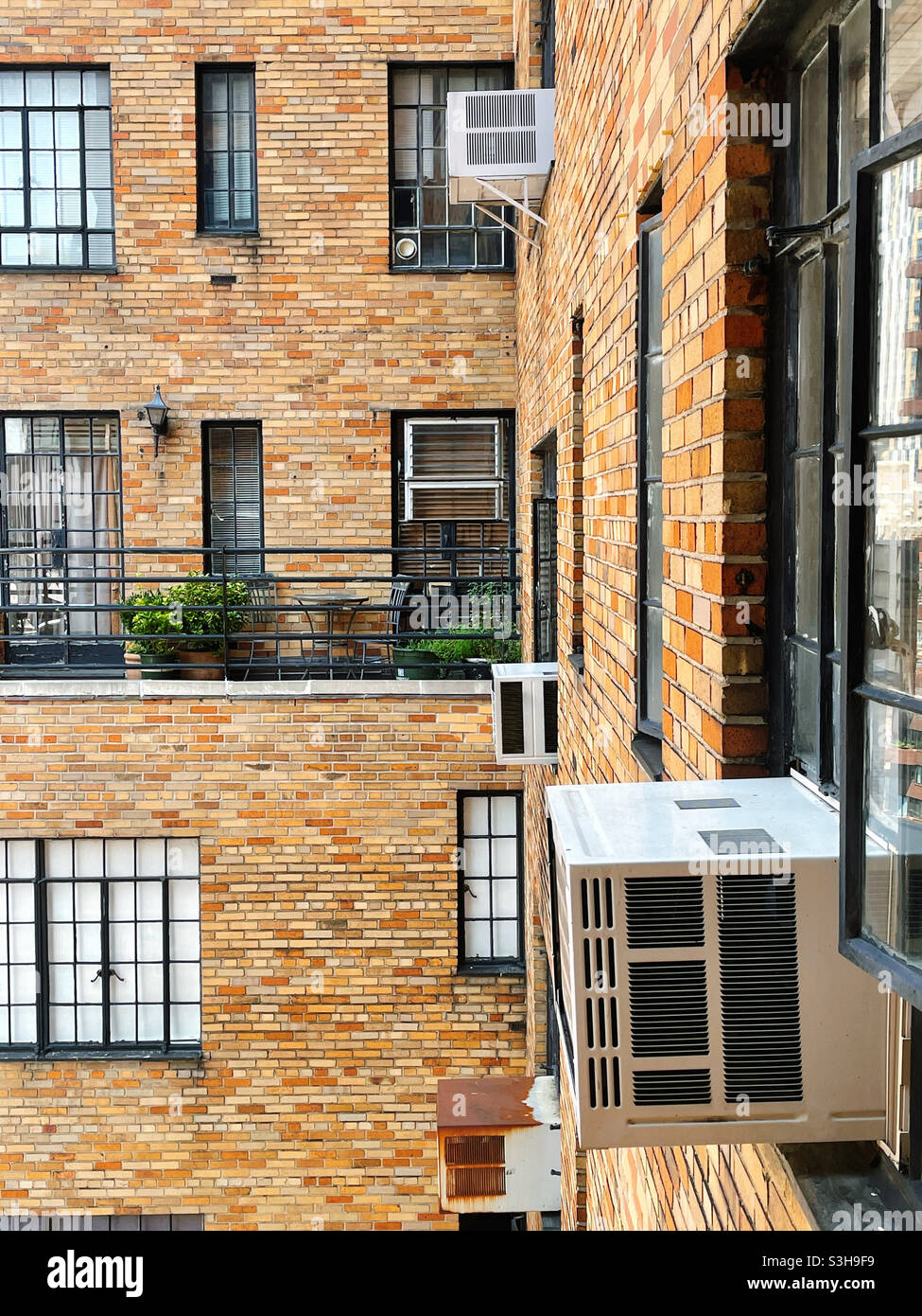 Window air conditioners are seen on the outside of this luxury Park Avenue co-op in Murray Hill during the hot summer of 2021, NYC, USA - Smartphone Captured Stock Image