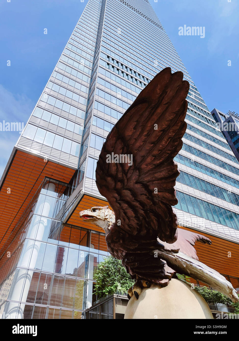 The huge cast iron bald eagle statue is above the Vanderbilt Avenue entrance to Grand Central terminal with the new super tall One Vanderbilt in the background, 2021, NYC, USA - Smartphone Captured Stock Image