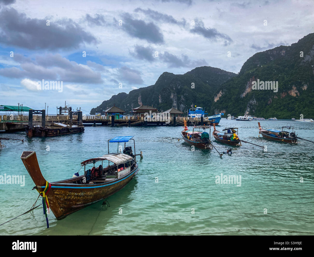 Long tail boats docked on the pier of Koh Phi Phi Island in Thailand. Stock Photo