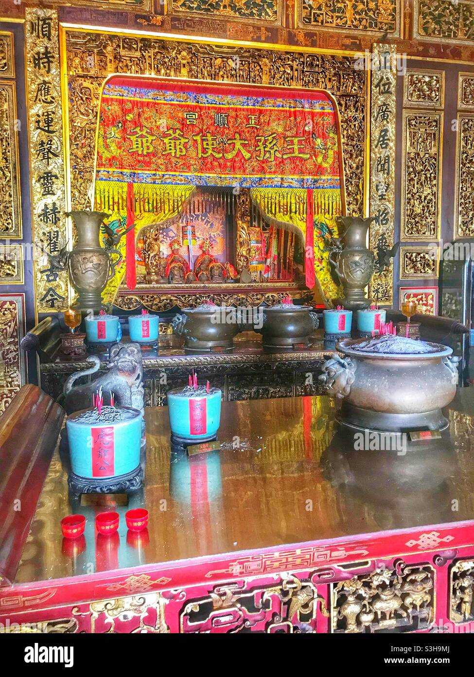 Incense burns at an altar at the Leong San Tong Khoo Kongsi clanhouse in George Town, Penang, Malaysia - Smartphone Captured Stock Image