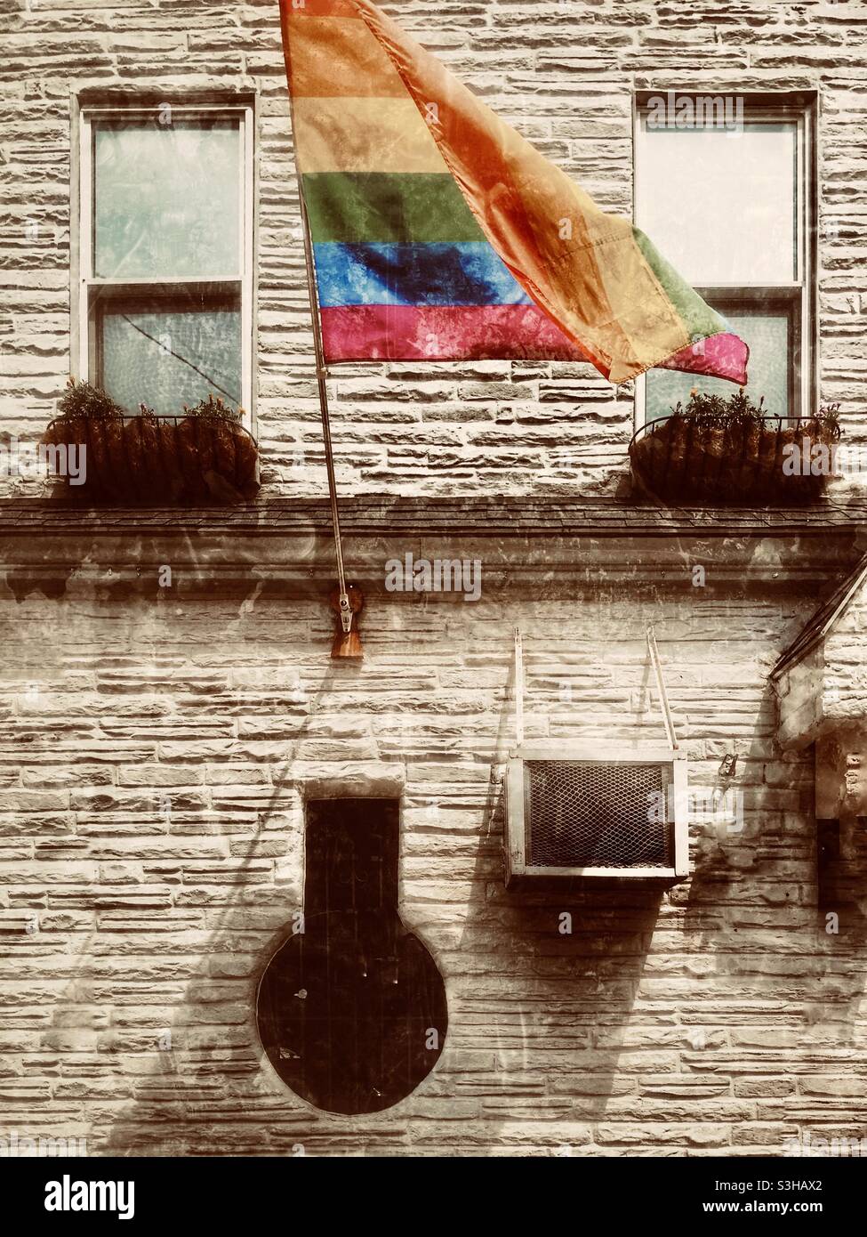 Lgbt Community Gay Club with Rainbow Flag on the Facade of a Brick