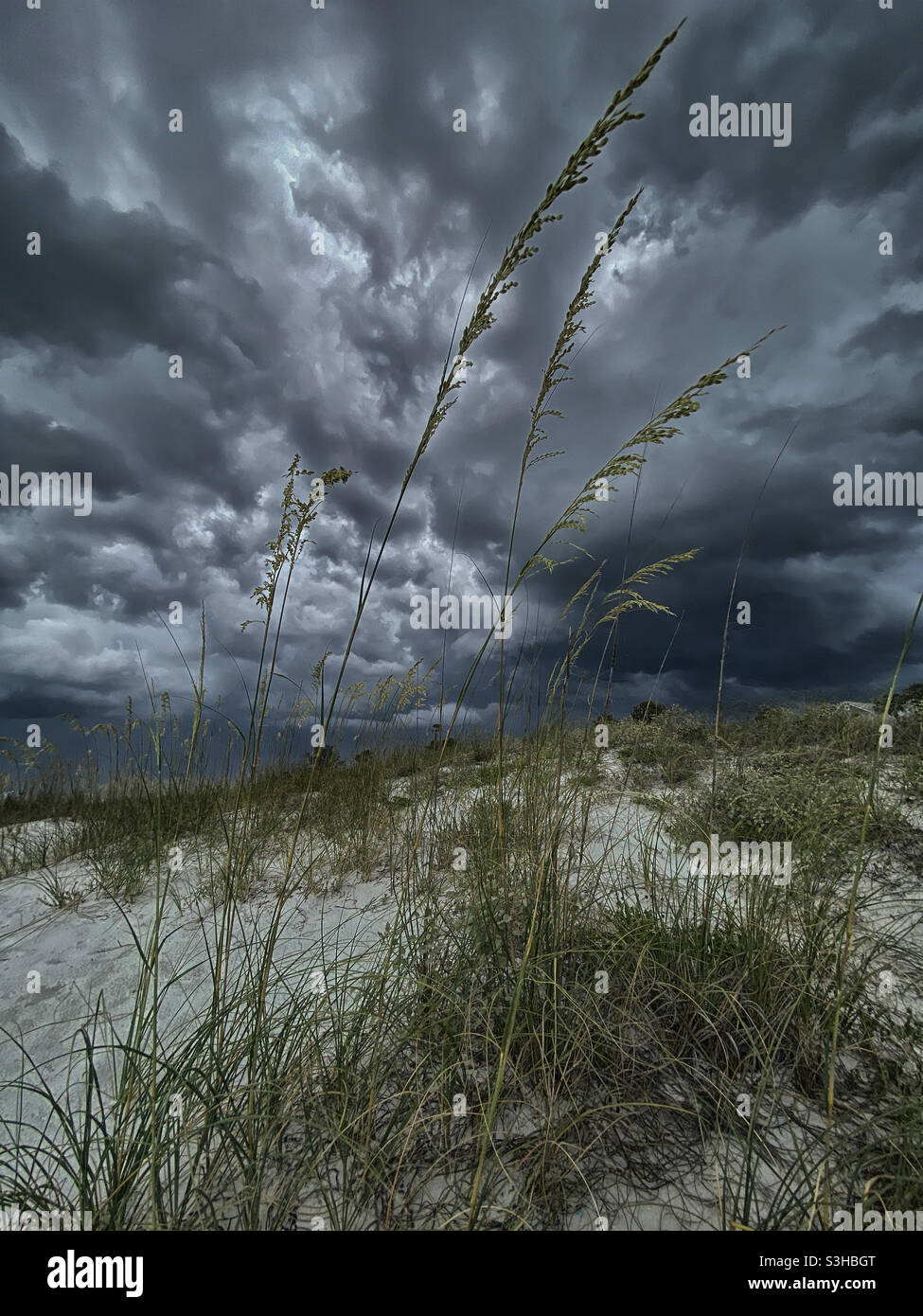 Low angle view of storm clouds on beach Stock Photo