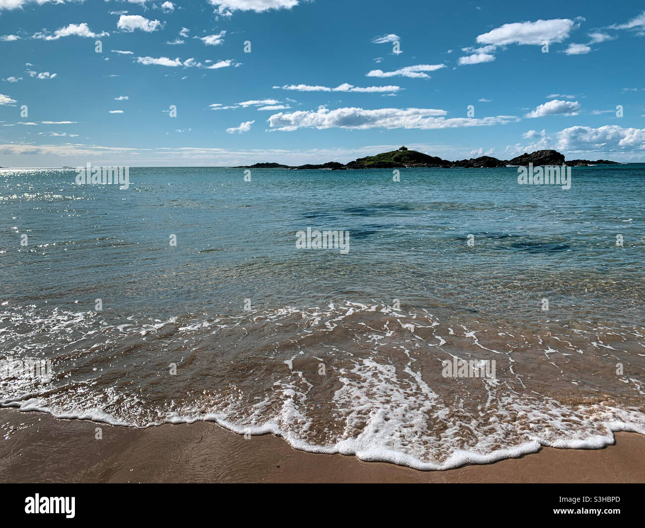 Beautiful blue green sea water lapping onto the shore at Sawtell beach, Australia, relax - Smartphone Captured Stock Image