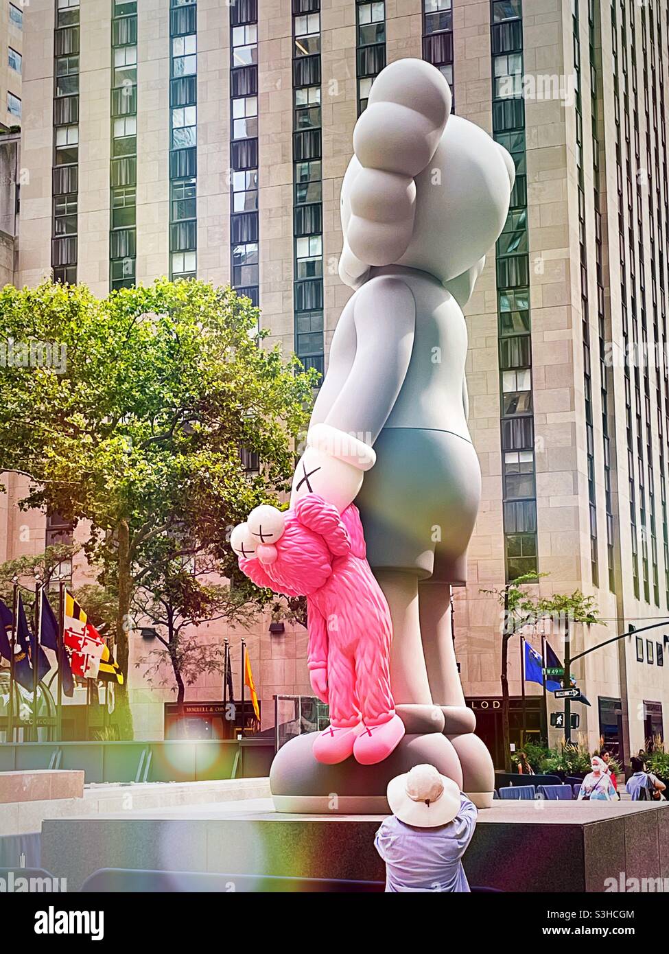 Kaws New commission, share, is located on the center plaza in front of 30 rock, NYC, USA, 2021 - Smartphone Captured Stock Image