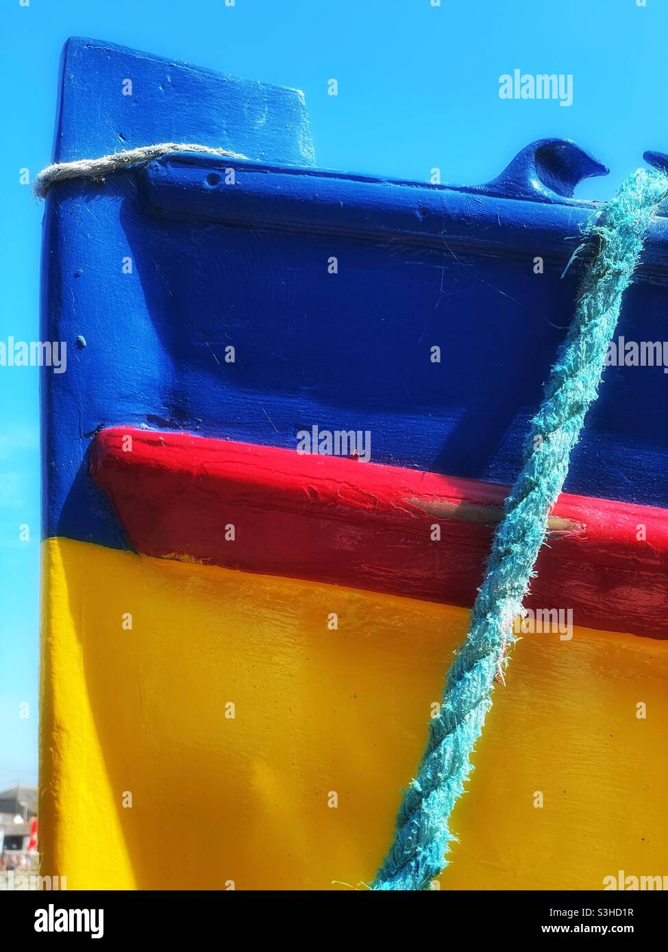 Detail of a colourful fishing boat moored in a Cornish harbour, August. - Smartphone Captured Stock Image