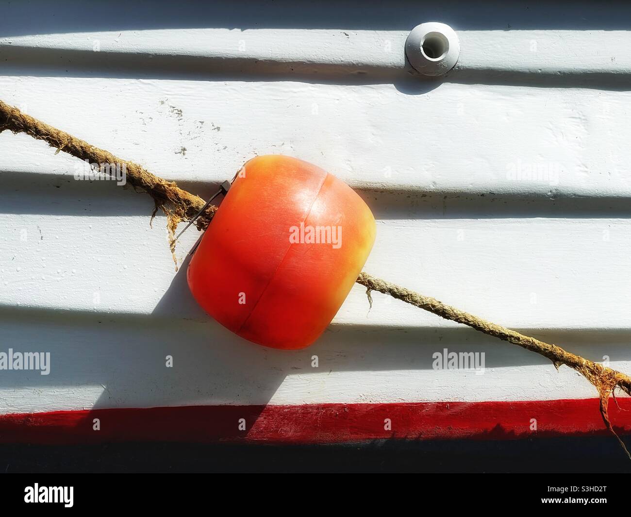 Detail of a colourful fishing boat moored in a Cornish harbour, August. - Smartphone Captured Stock Image