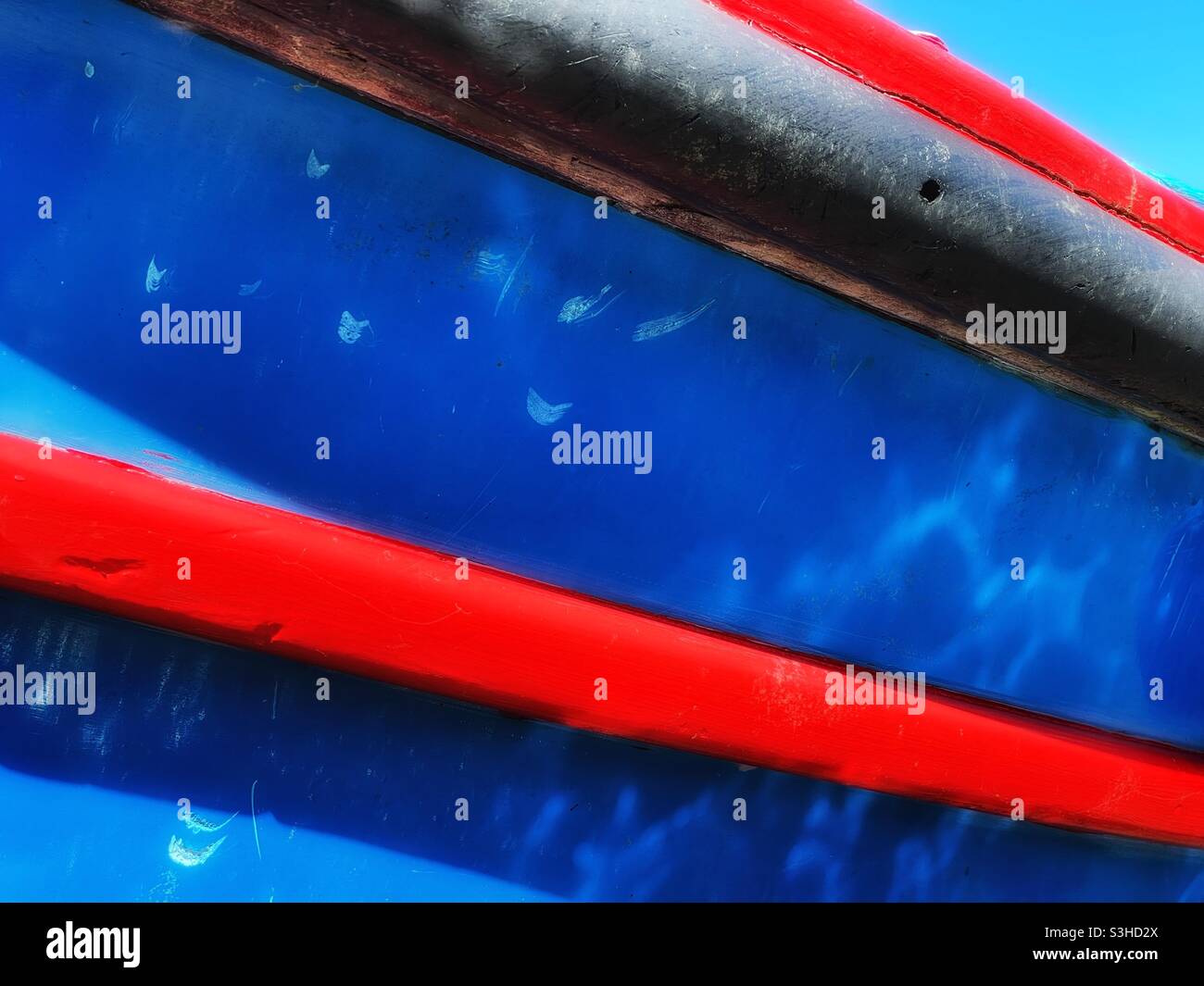 Detail of a colourful fishing boat moored in a Cornish harbour, August. - Smartphone Captured Stock Image