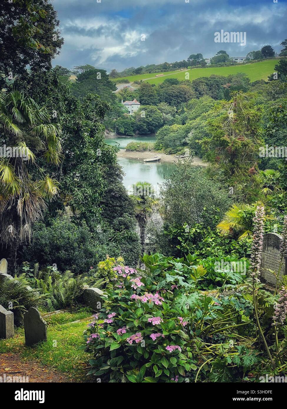 St Just in Roseland Church graveyard looking over the water. Stock Photo