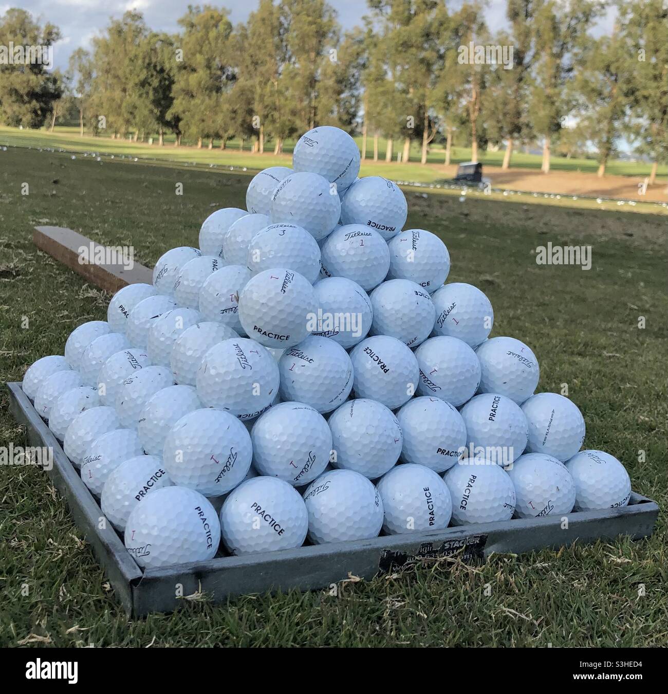 A pyramid of golf balls at the driving range Stock Photo - Alamy