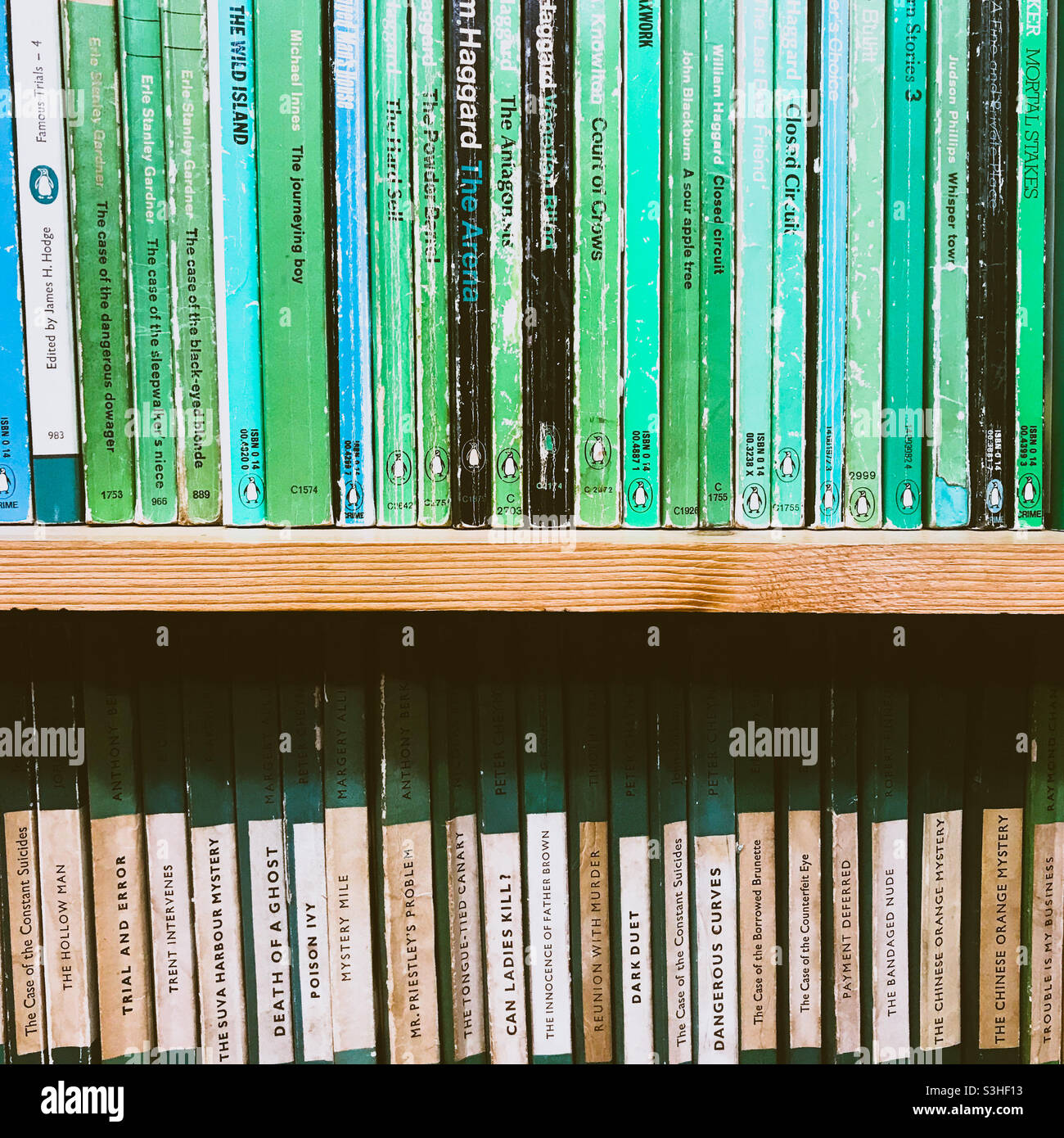 Green spine penguin books in a second hand book shop - Smartphone Captured Stock Image