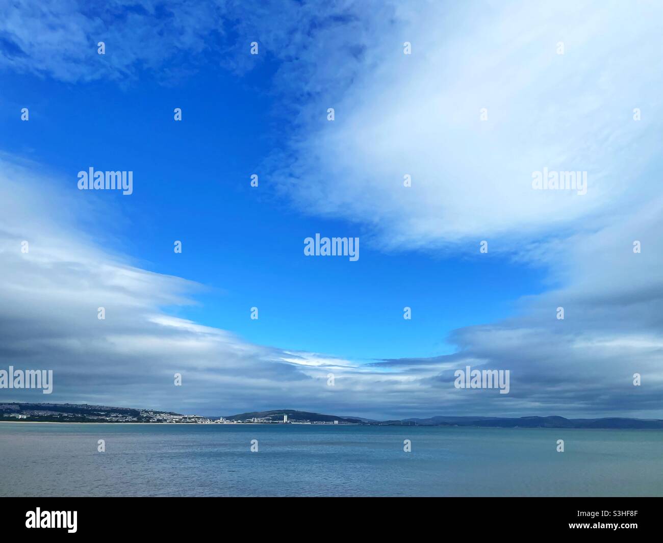 Break in the clouds over Swansea Bay, Wales. Stock Photo