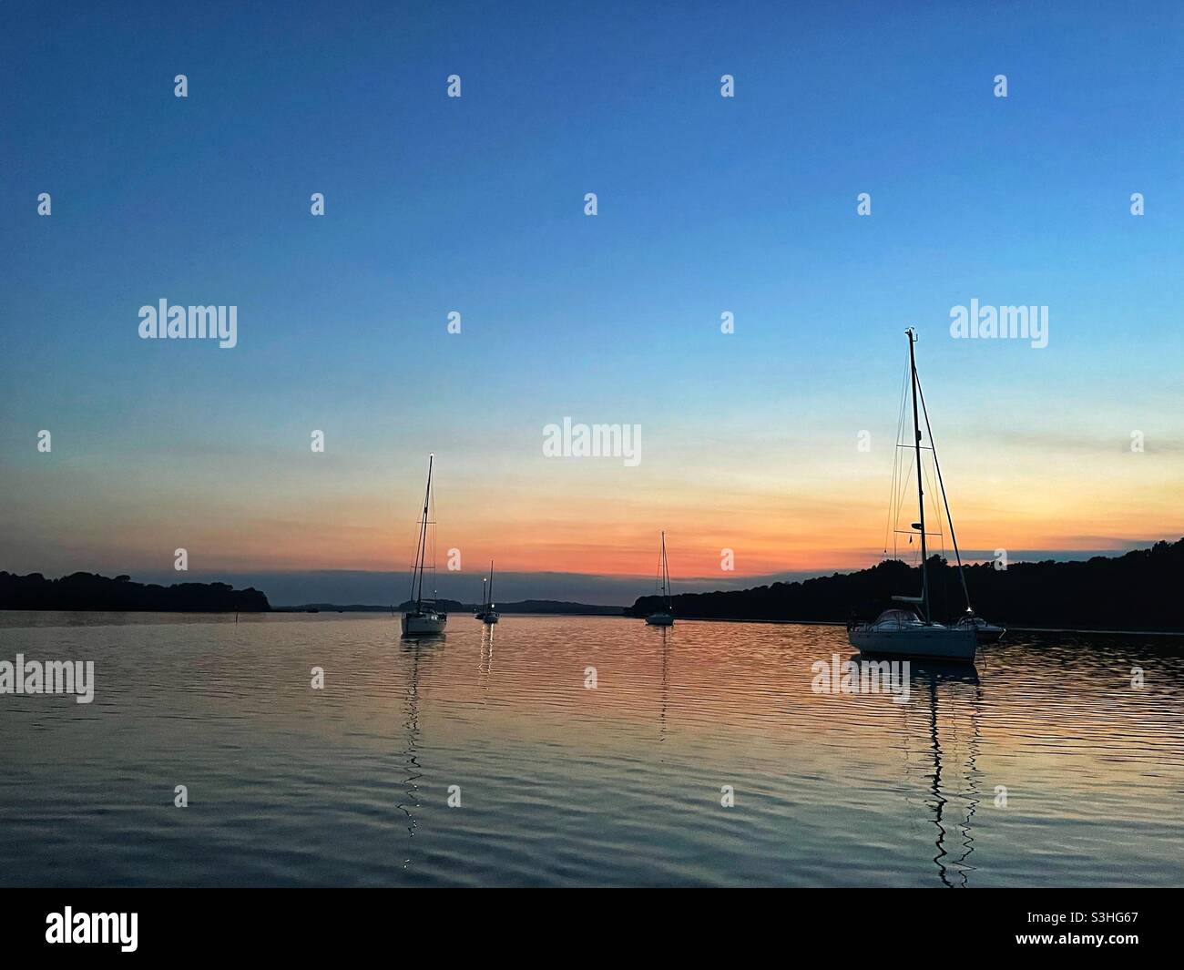 Twilight and evening calm at an anchorage in Poole Harbour on the south coast of England - Smartphone Captured Stock Image