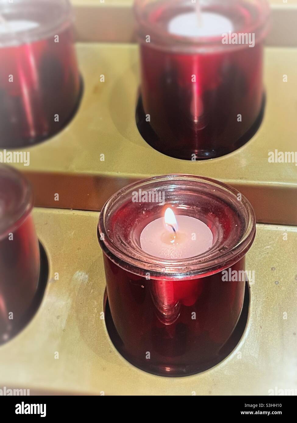 Close up of votive prayer candles lit in a Catholic Church, NYC, USA - Smartphone Captured Stock Image