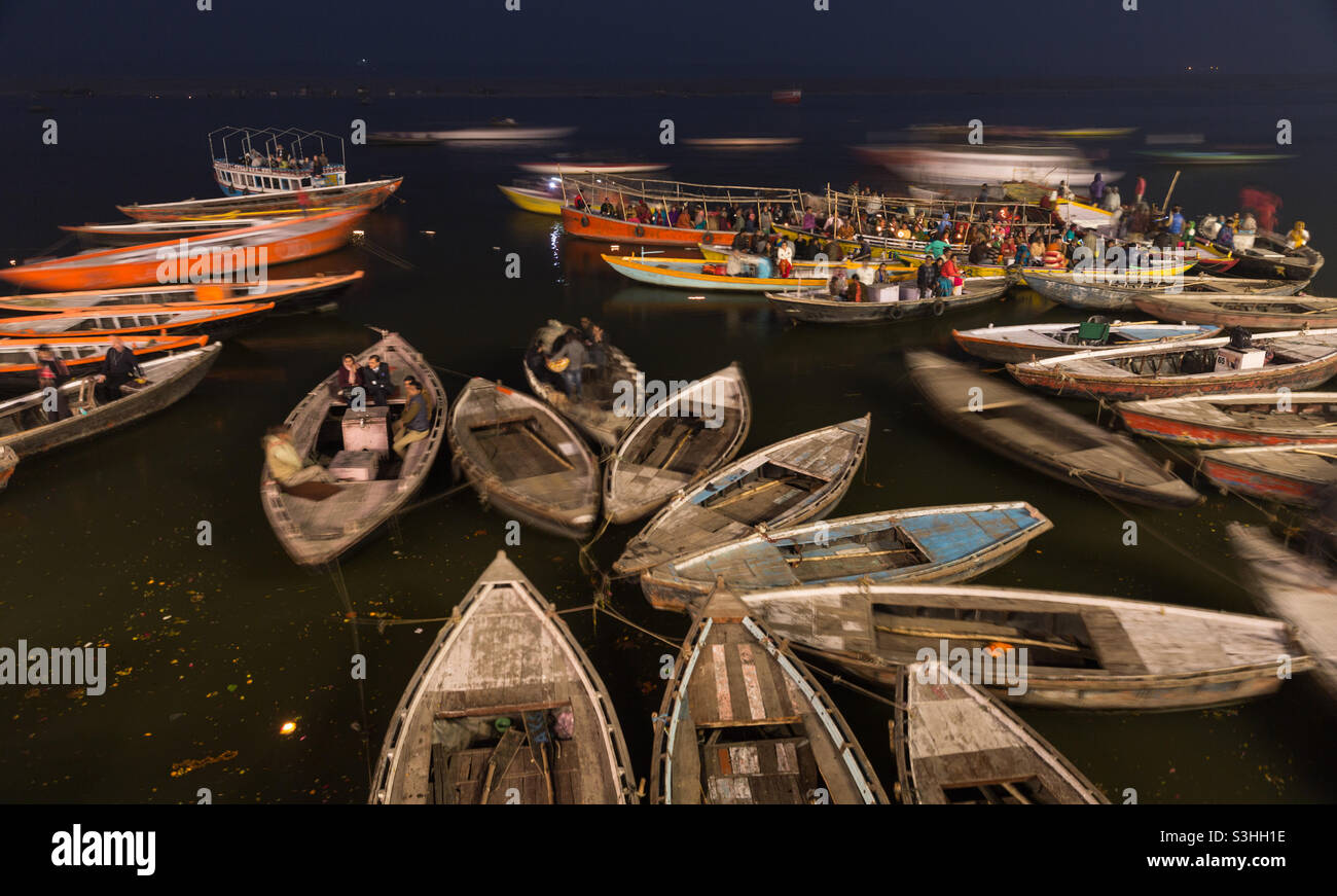 Ghats of Ganges in Varanasi, people gathering in the evening on boats for worshiping river Ganges in India - Smartphone Captured Stock Image