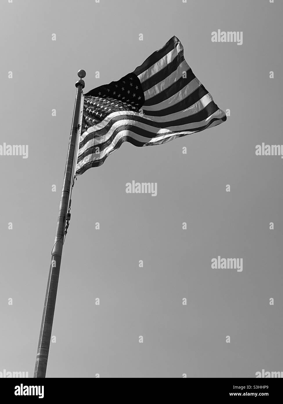 United States flag flying high in the sky and wind on a summers afternoon Stock Photo