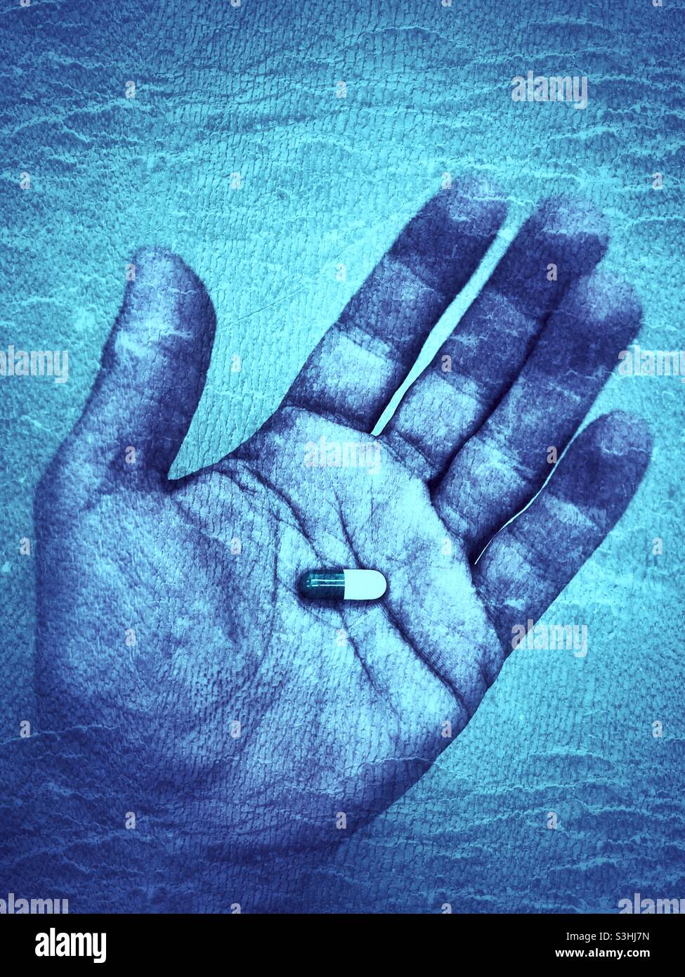 Hand with pill in it, pain addiction concept - Smartphone Captured Stock Image