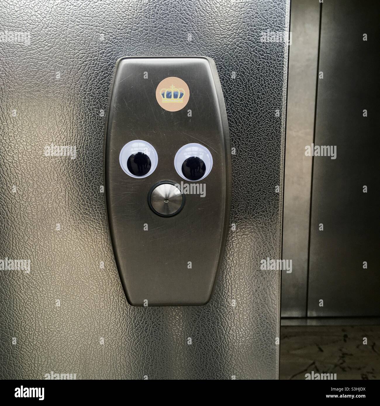 Googly eyes on elevator buttons Stock Photo Alamy