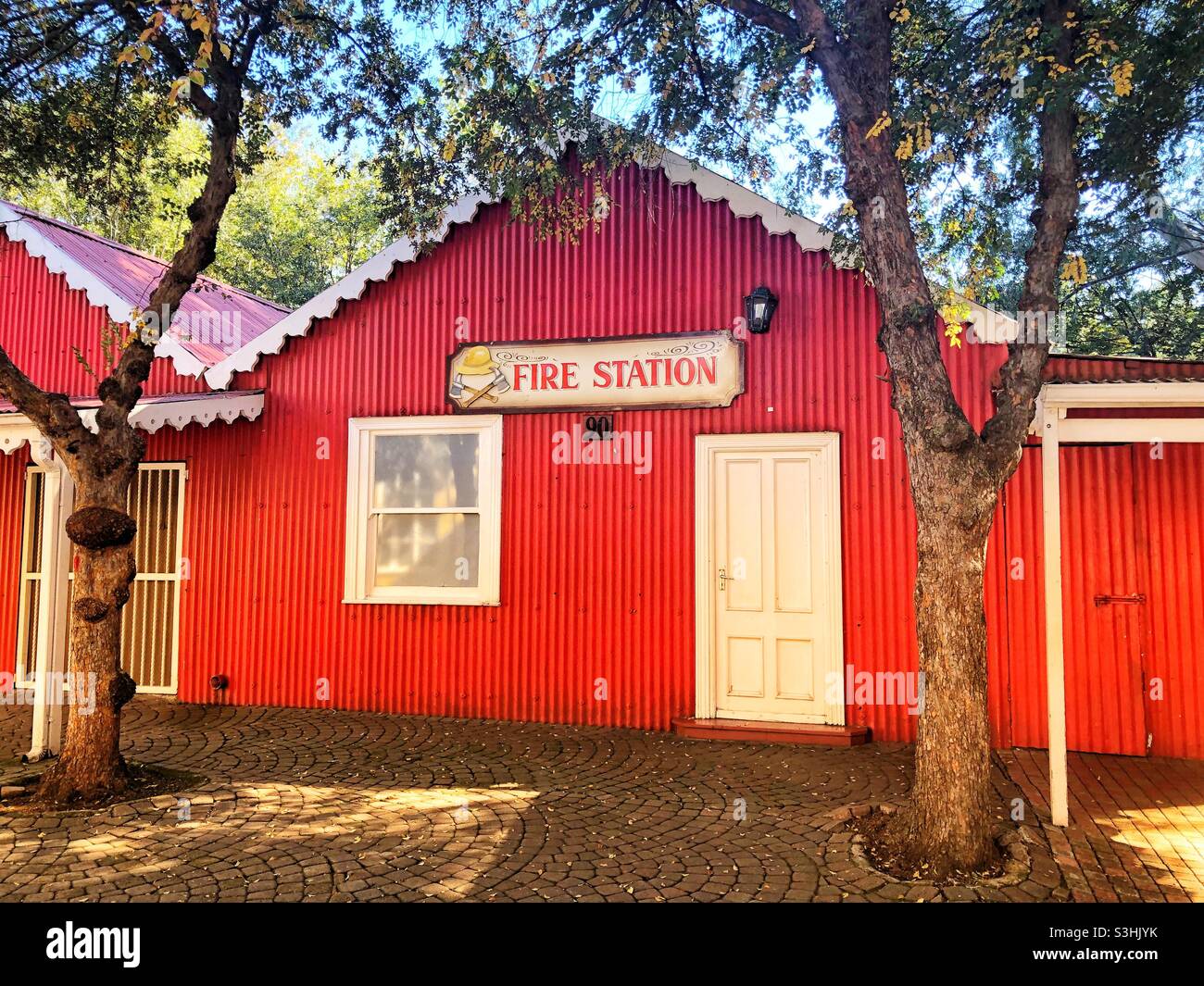 Red building with a fire station sign at the very popular theme park Gold Reef City in Johannesburg, South Africa - Smartphone Captured Stock Image