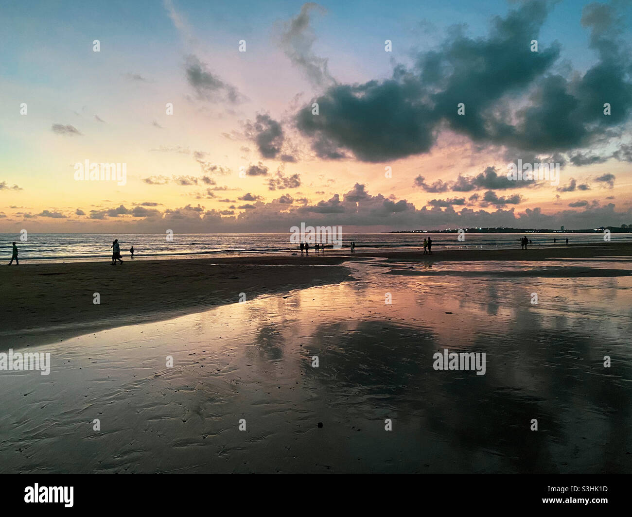 Beach opens on relaxation of lockdown, of second wave. People visit Juhu beach in Mumbai during sunsets. - Smartphone Captured Stock Image