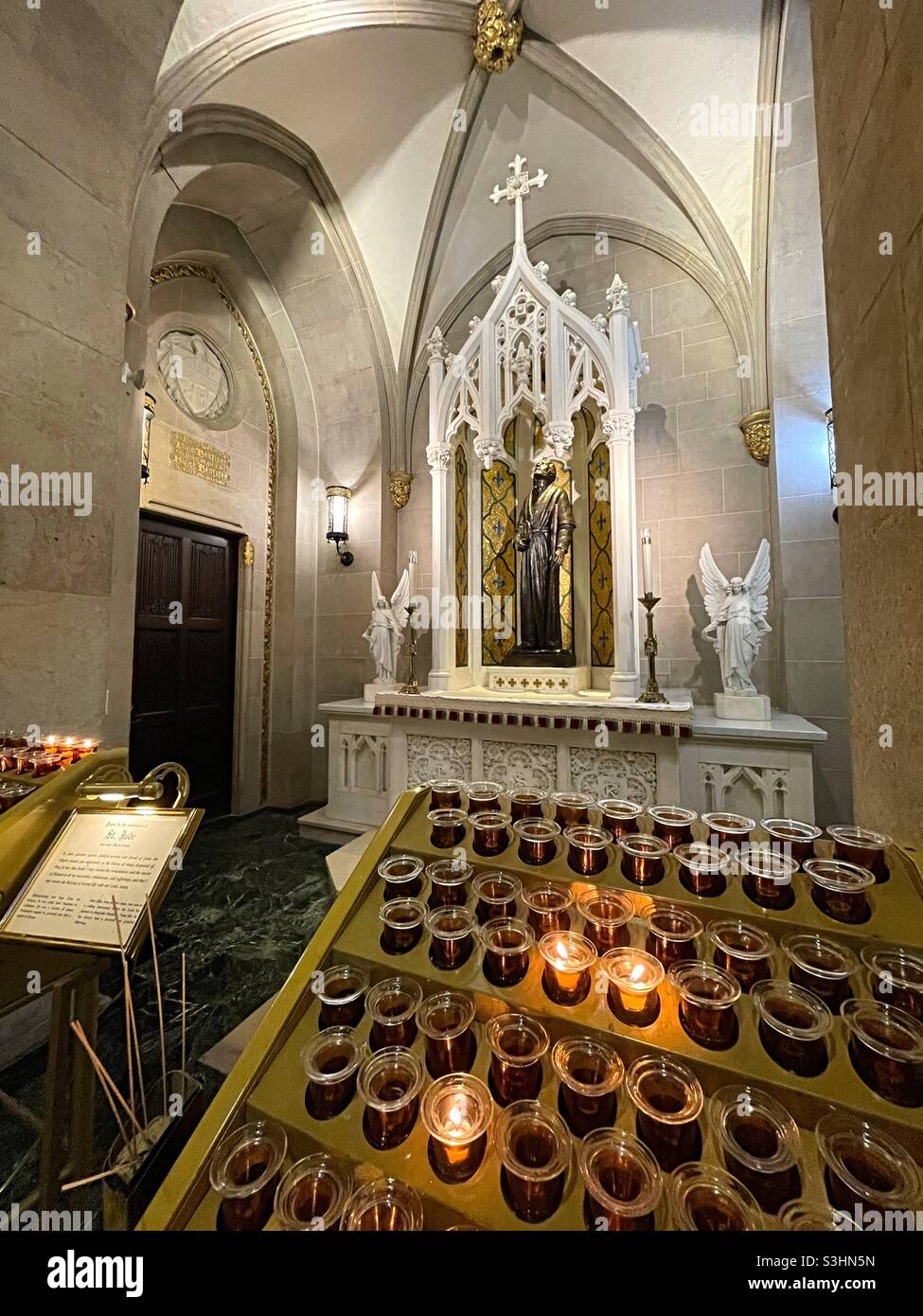 Saint Judes side altar and votive candle display rack in the interior of St. Patrick’s Cathedral, USA - Smartphone Captured Stock Image