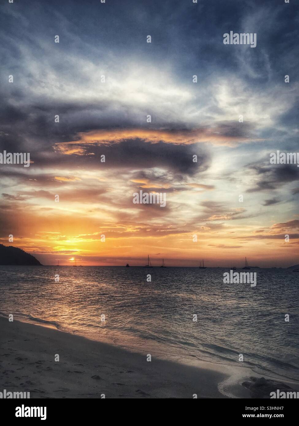 Vertical scenic view of sunset at Sunset Beach on Koh Lipe, southern Thailand - Smartphone Captured Stock Image