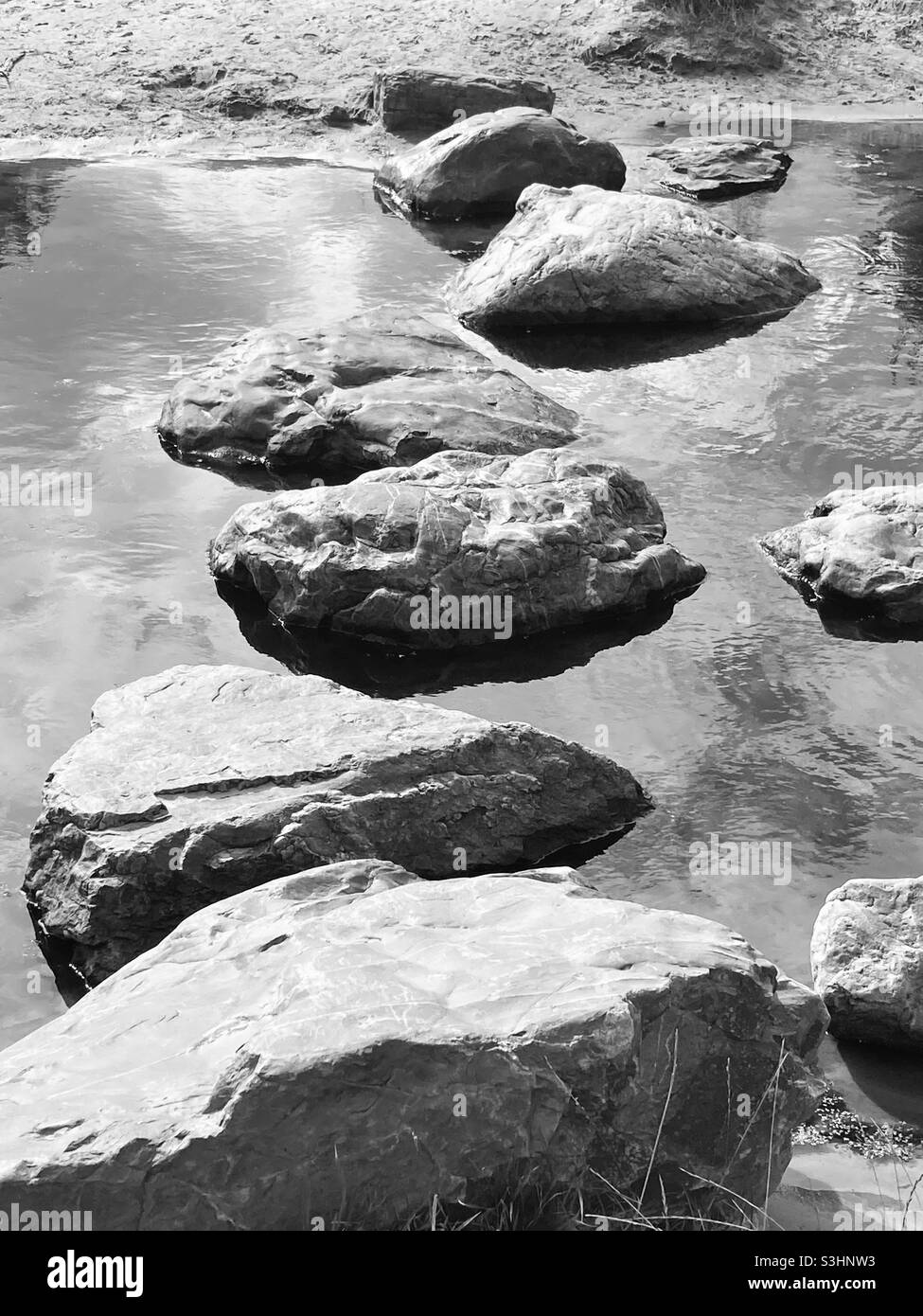 Stepstones as a path across a river - Smartphone Captured Stock Image