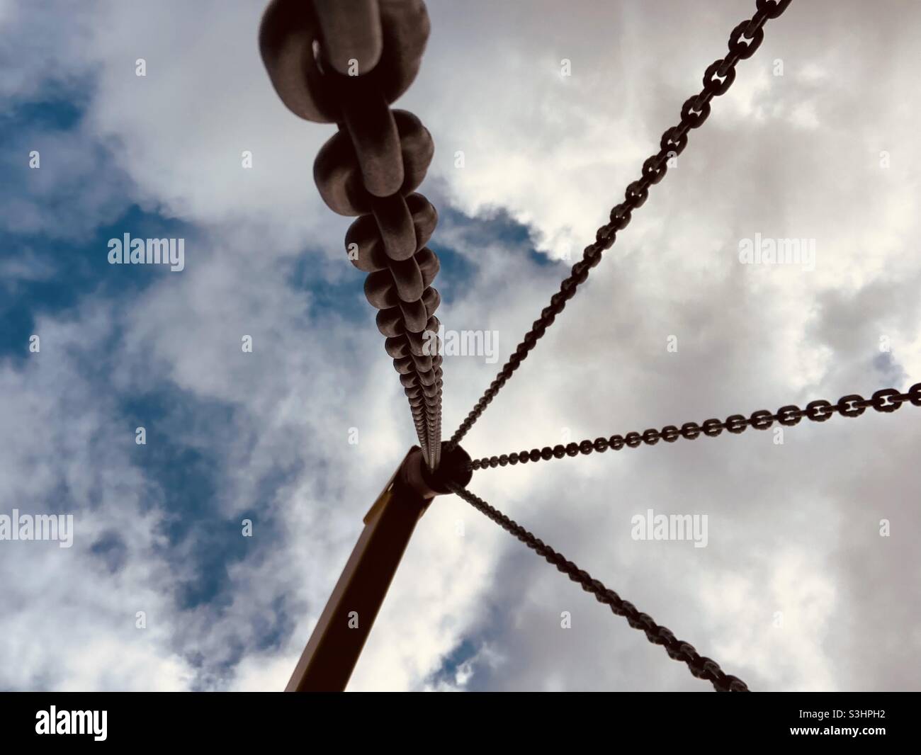 Four Chains upview in front of cloudy Sky - Smartphone Captured Stock Image
