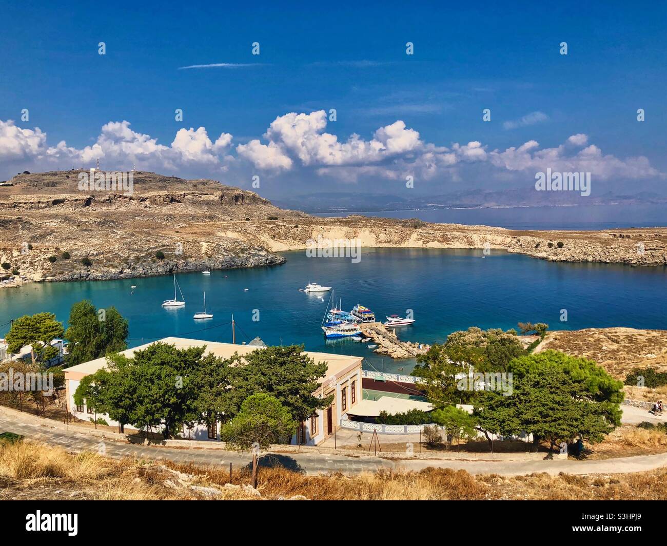 View at Lindos harbor with boats on Rhodes island, Greece. - Smartphone Captured Stock Image
