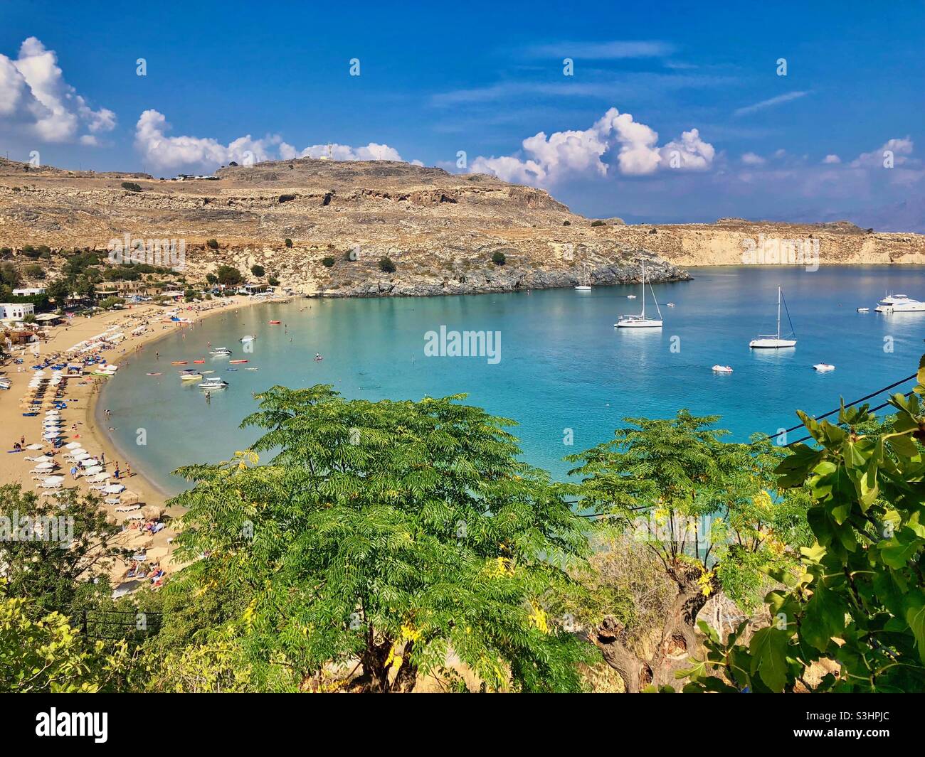 View at Lindos beach with boats on Rhodes island, Greece. - Smartphone Captured Stock Image