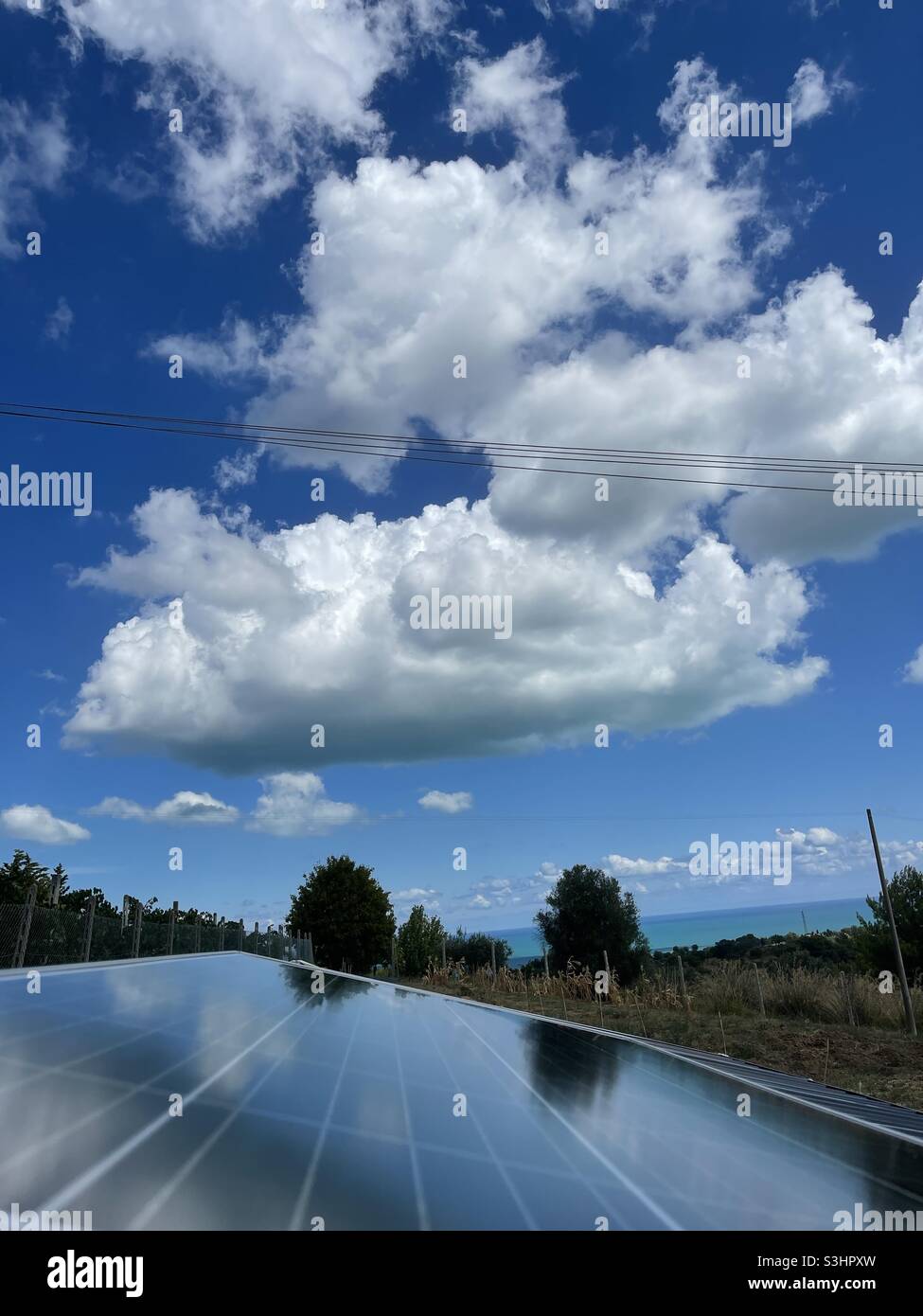 Solar panel under a sunny and cloudy day - Smartphone Captured Stock Image