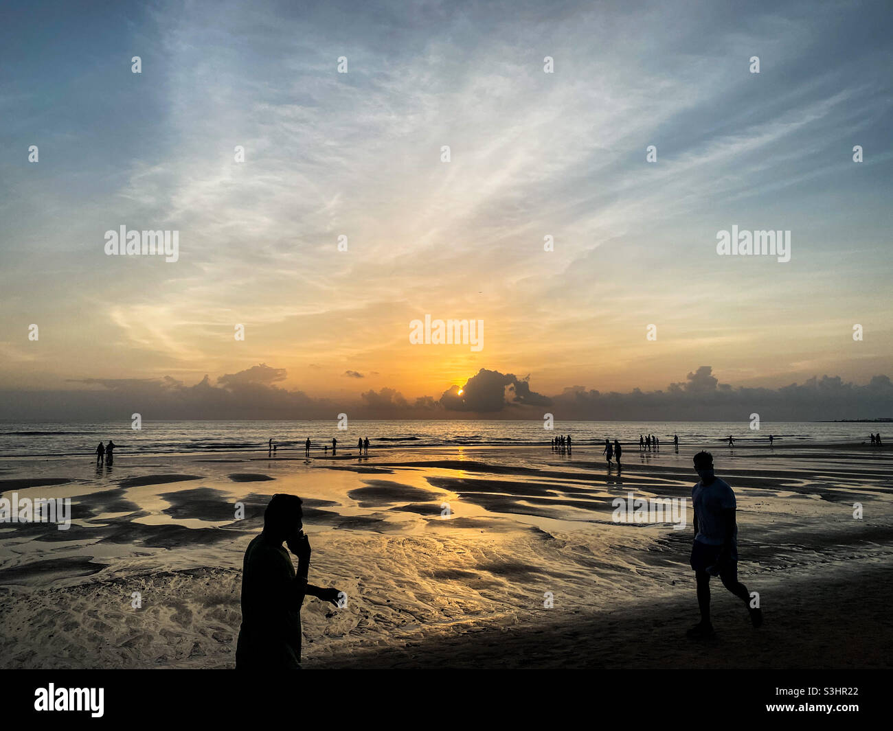 Citizens take evening walk on Juhu Beach after governments eases on lockdown in Mumbai, India. - Smartphone Captured Stock Image