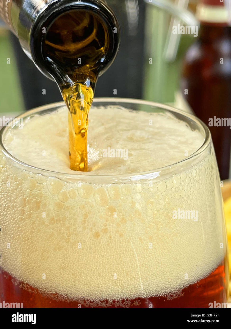 Pouring beer in a glass. Close view. - Smartphone Captured Stock Image