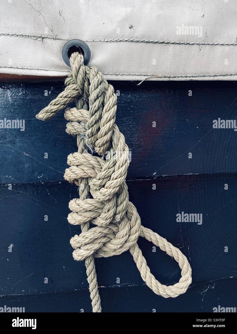Complex knot fixes a ship's tarpaulin - Smartphone Captured Stock Image