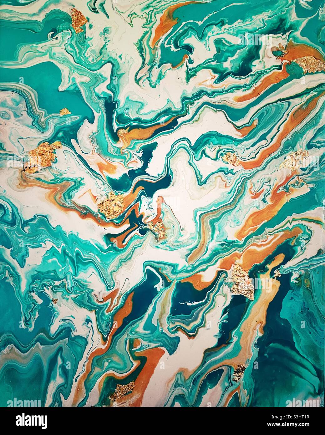 A photograph of a turquoise and gold pour painting. Fluid ink art with gold leaf Stock Photo