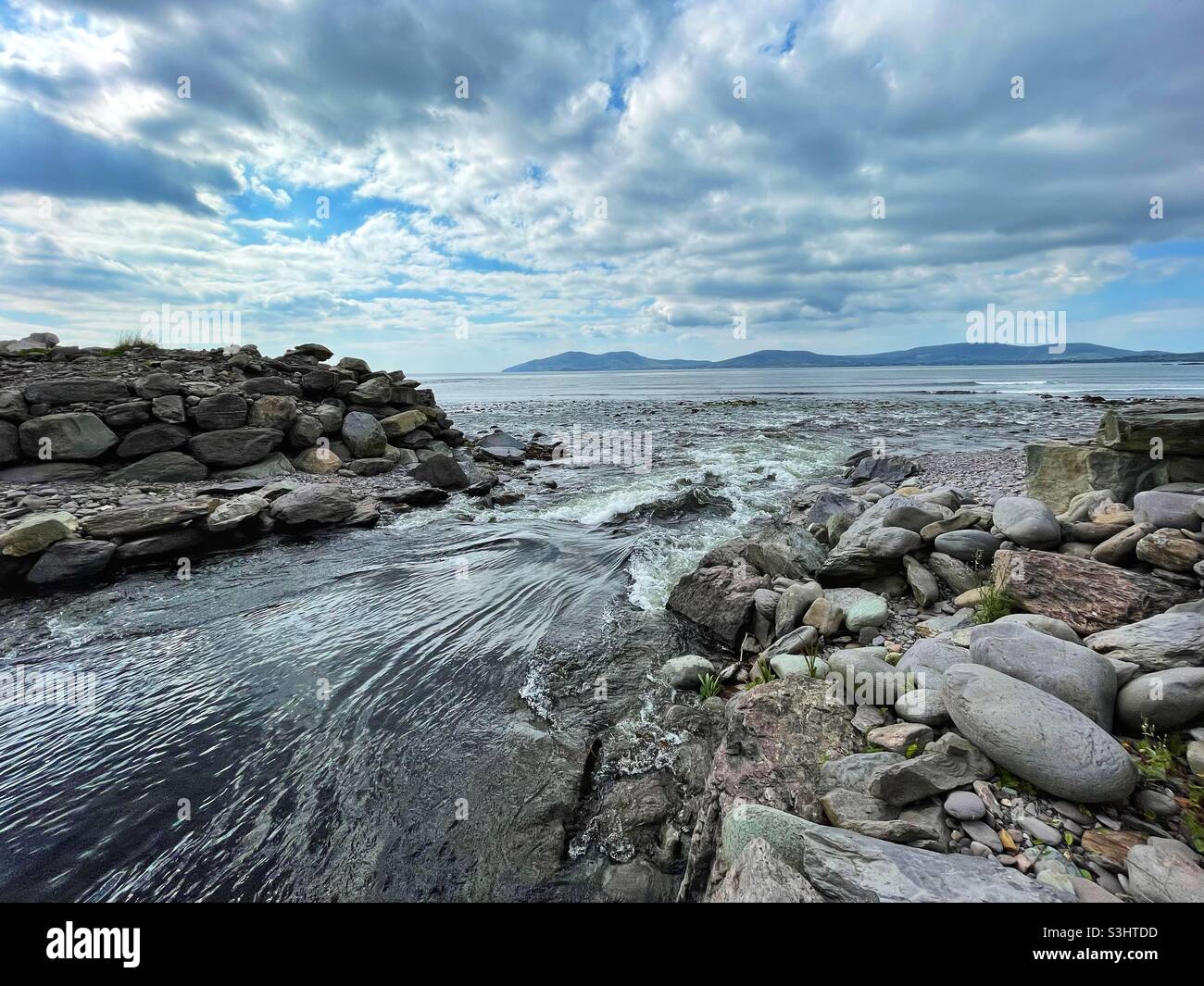 Outflow of Lough Currane from the Butler pool onto Waterville beach, County Kerry, Ireland, August. - Smartphone Captured Stock Image