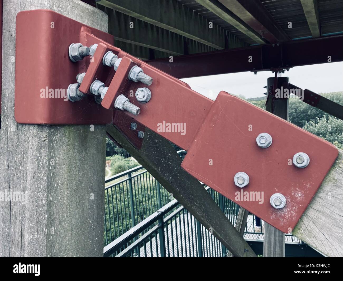 red metal frame is fixed with gray metal screws and nuts - Smartphone Captured Stock Image