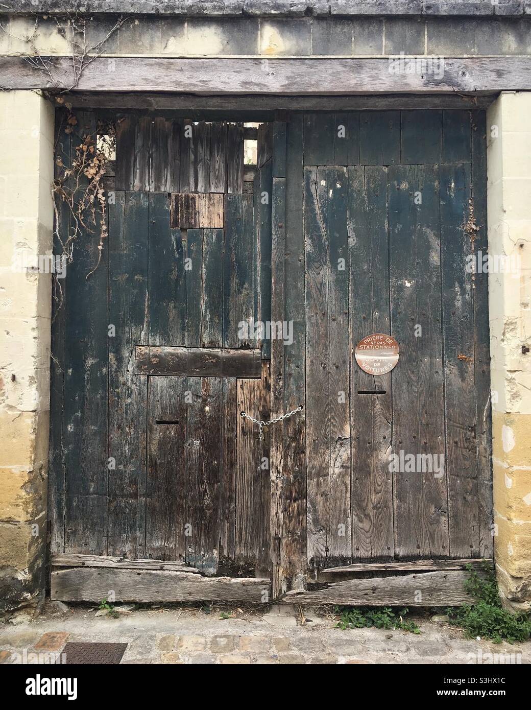 Ancient doors on a derelict property in the medieval town of Chinon in France. Stock Photo