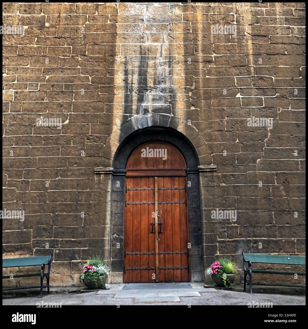 Gamle Aker Kirke. Entrance and front facade of the oldest standing building in Oslo, Norway, a limestone church built ca 1130-1180. - Smartphone Captured Stock Image