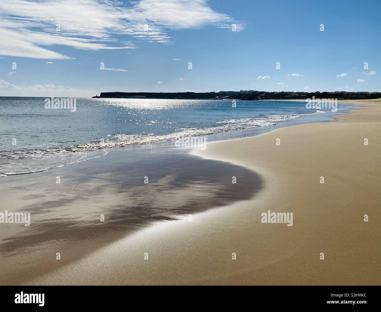 Beach scene with sun reflecting in water - Smartphone Captured Stock Image