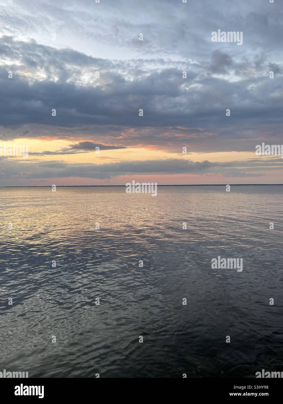 Cloudy skies sunset reflecting hi-res stock photography and images - Alamy
