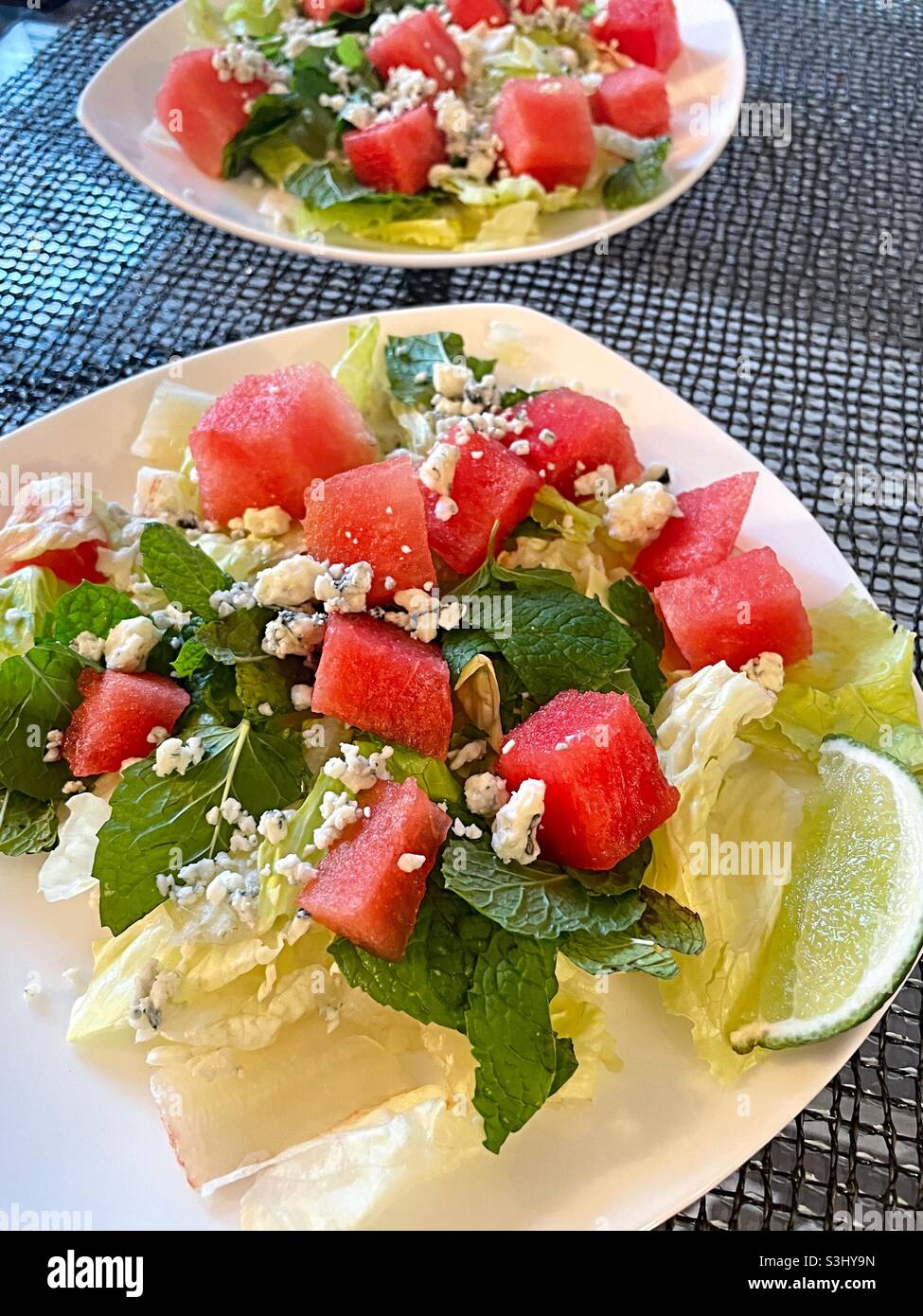 Close up of fresh green salad and chopped watermelon with blue cheese crumbles, NYC, USA Stock Photo