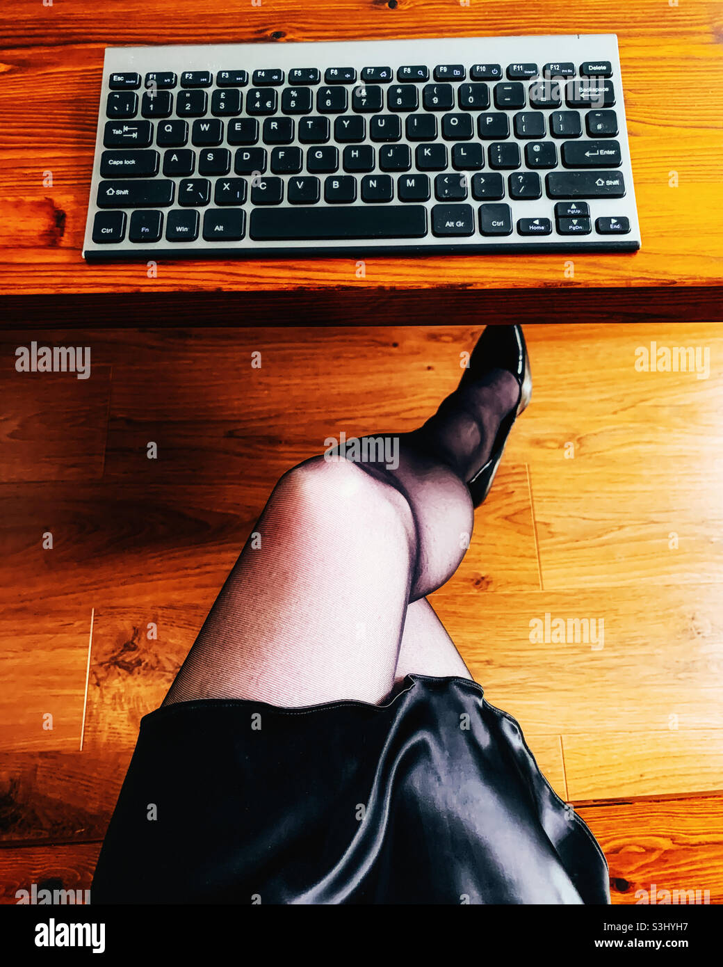 Crossed legged woman working from home - Smartphone Captured Stock Image