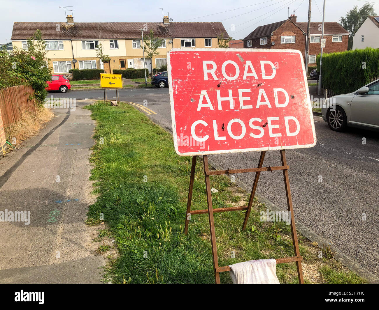 Road signs giving notice of a closed road and diversion in place. - Smartphone Captured Stock Image